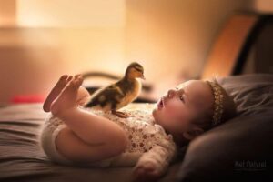 Charming Portraits of Newborn Babies Snuggling With Baby Animals